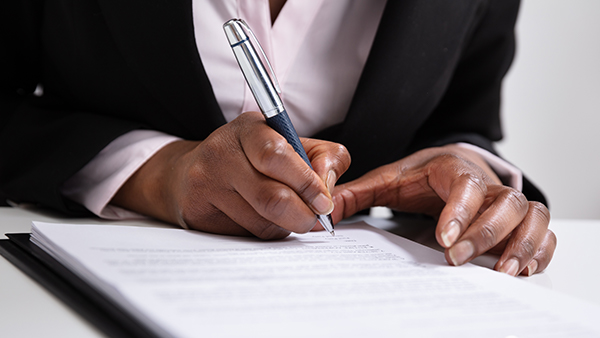 Woman Signing Paperwork